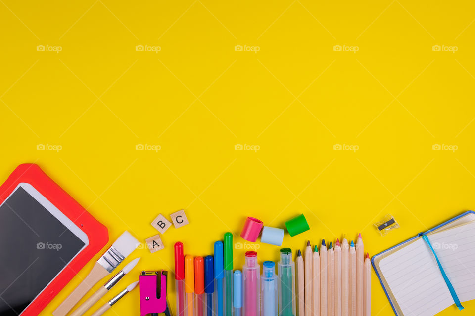 Set of school items on orange background. Back to school concept. Top view. Copy space