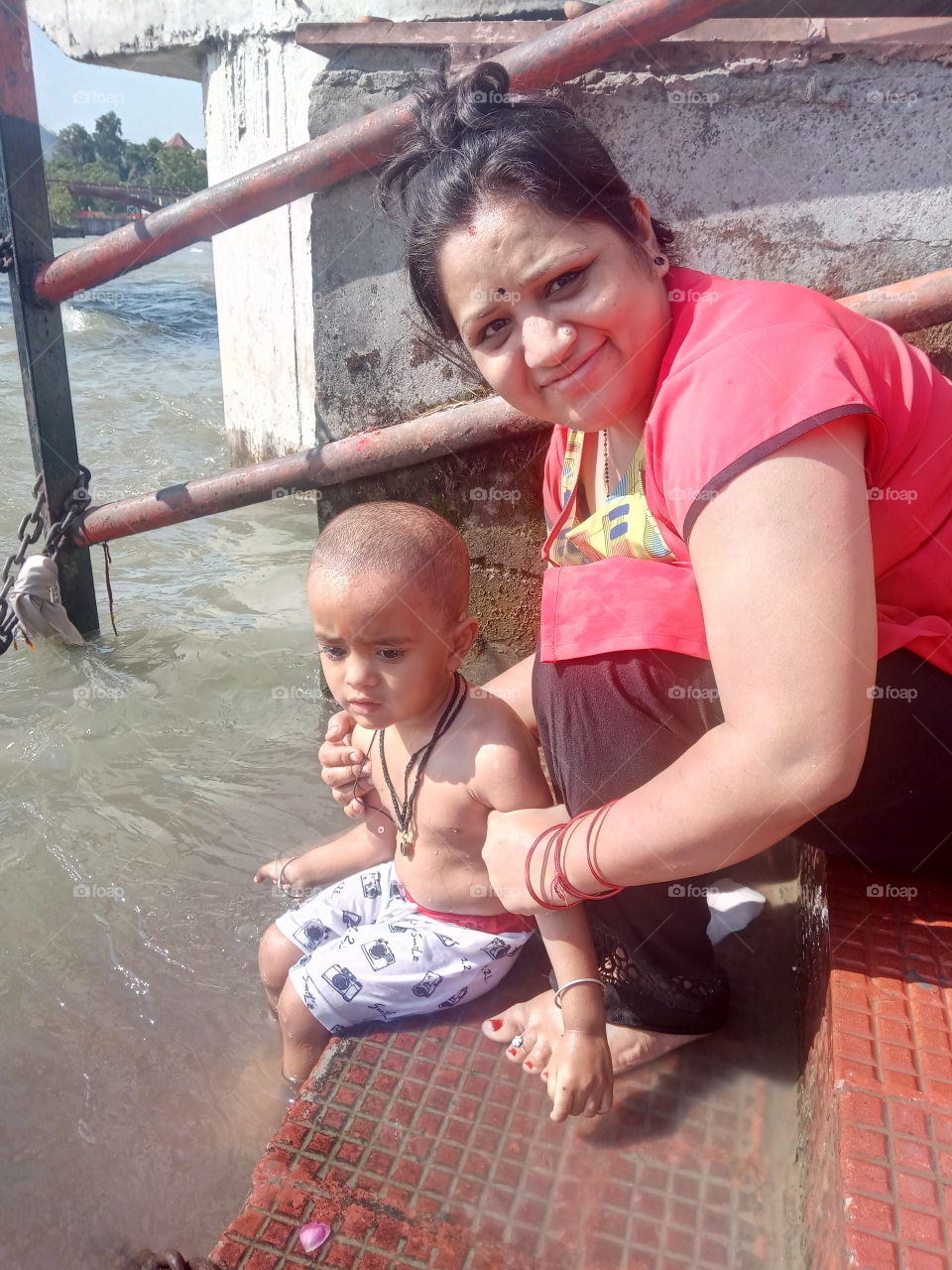 Monther and Son in Ganga River