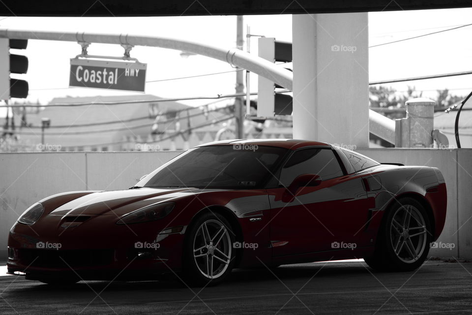 red corvette. corvette in a parking garage