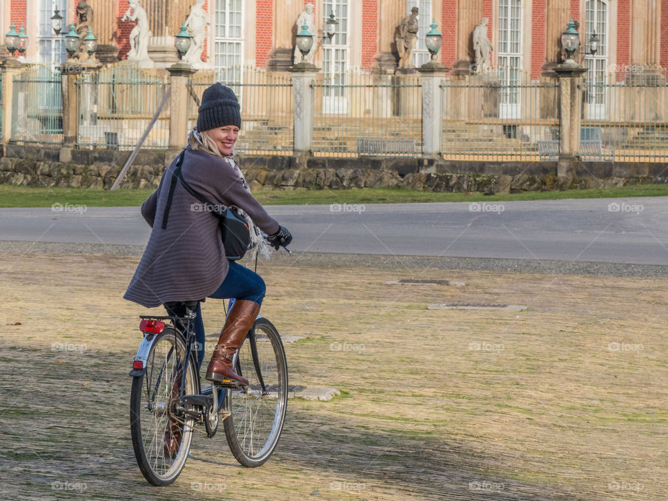 Woman bicycling in Potsdam, Germany.  