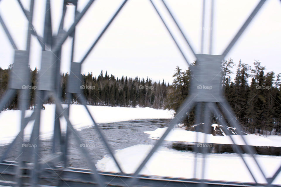 crossing a bridge on a northern winter road