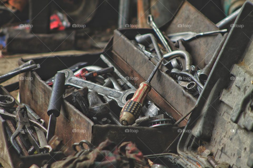 car mechanic box with various car repair tools. a metal box in which there are keys, files, screwdrivers and heads of different sizes