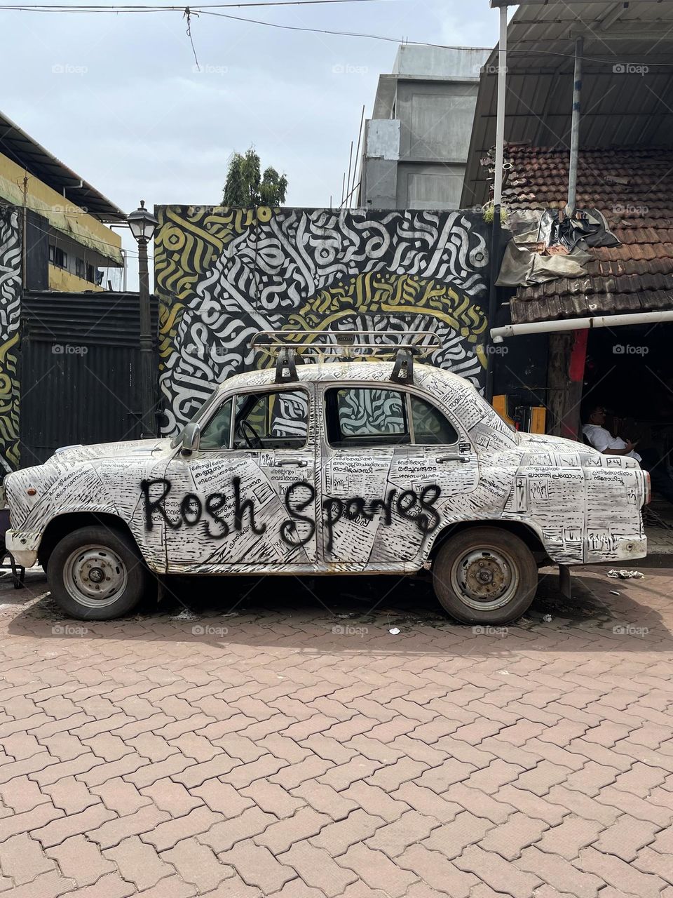 Abandoned car as a name board for a mechanic shop