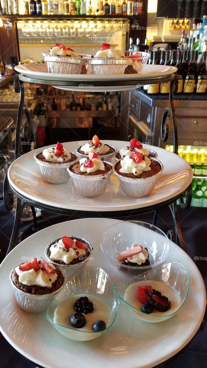 Delicious cupcakes on stand in restaurant