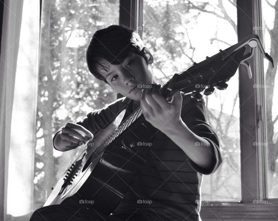 Guitar boy . Young boy playing guitar