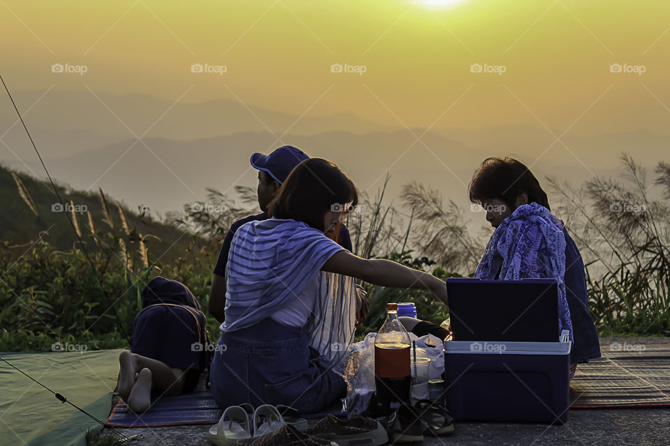 Tourists watch light sunset behind the mountains Nern Chang Suek  hills, Kanchanaburi, Thailand