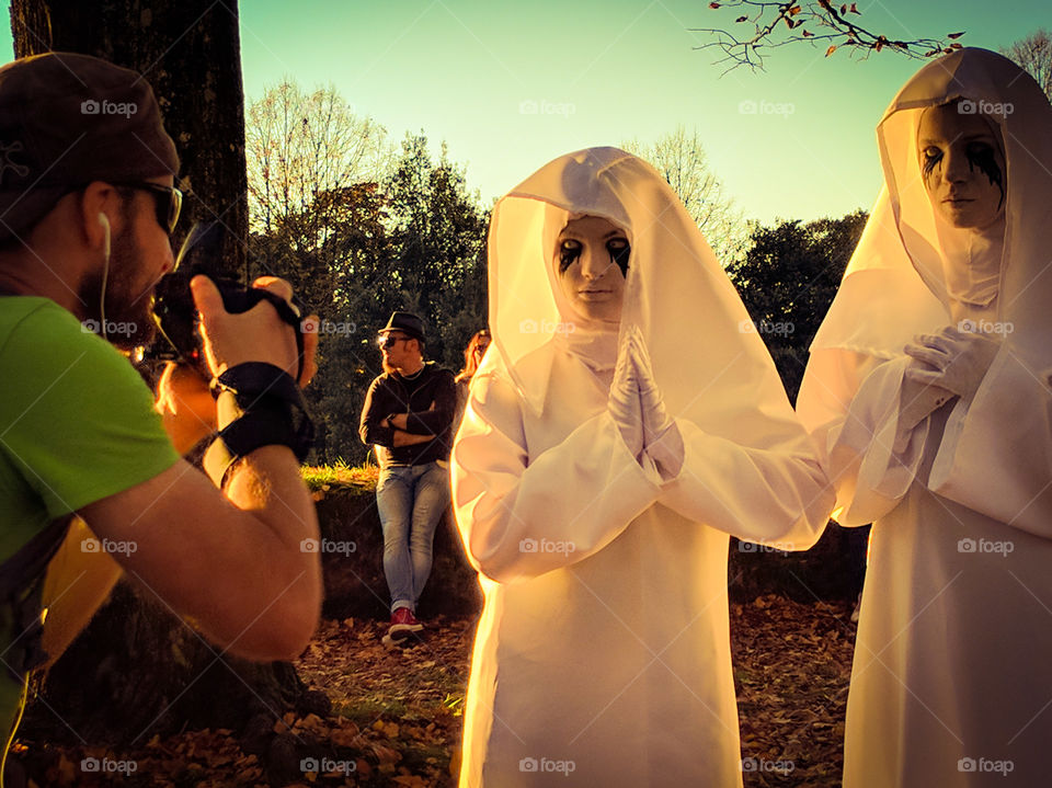 Photographer captures two masks dressed ad a buon, the party or Lucca Comica and Games.
