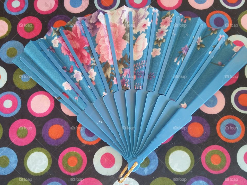 Elevated view of hand fan on table