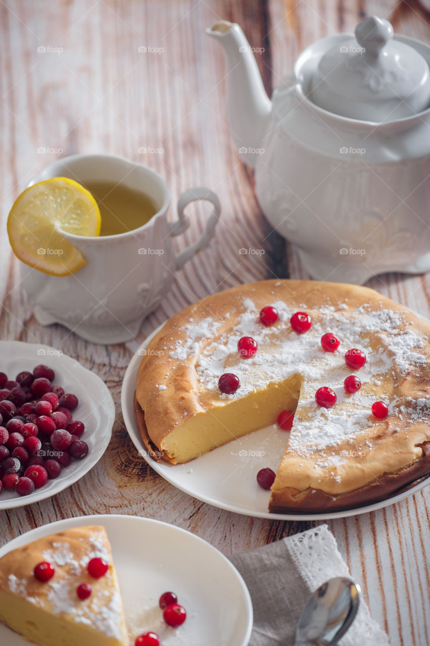 Cheesecake with cranberries and sugar on wooden background 