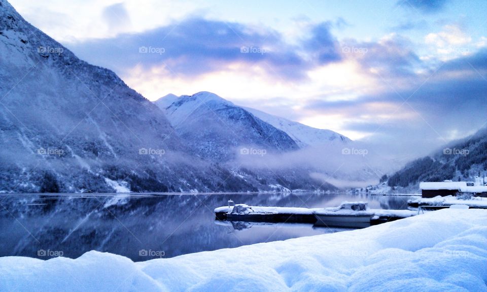 Reflection of snowy mountains againts idyllic lake