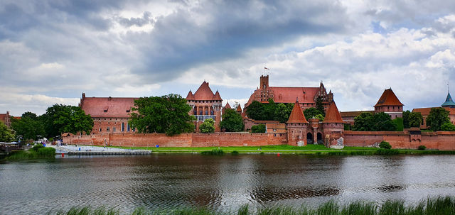 Historical castle of the Teutonic Order in Malbork seeing from the other side of river Nogat