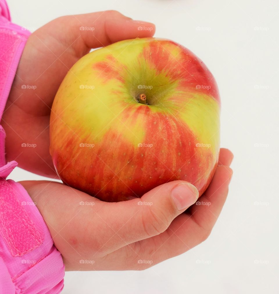 A child holding an apple