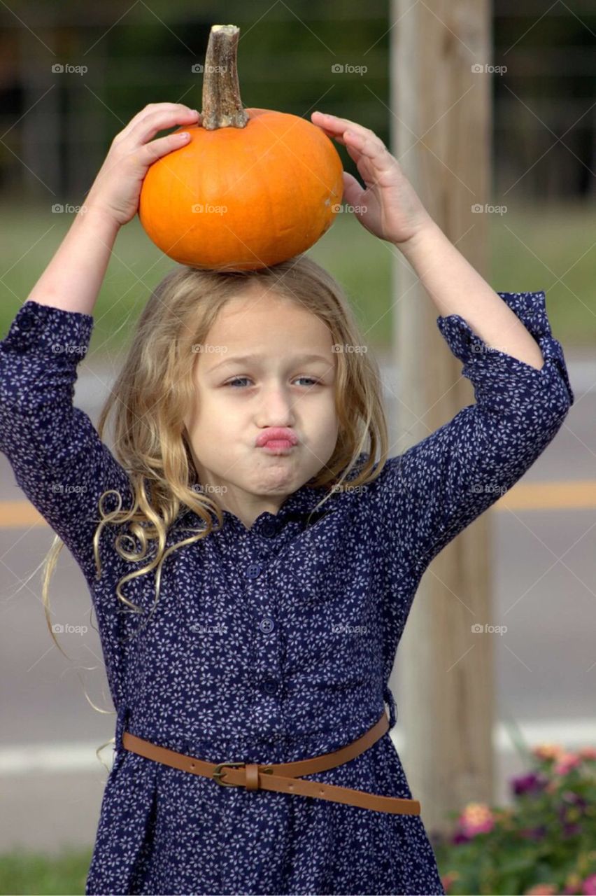 Close-up of a girl holding pumpkin