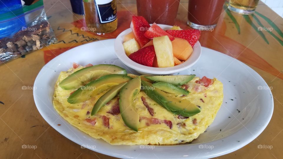 breakfast omelette with avocado and fruit