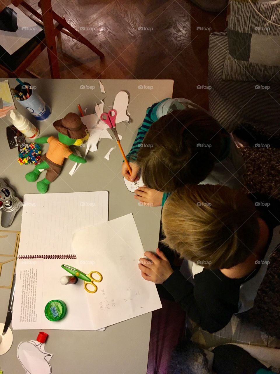 Two brothers doing homework together, from above
