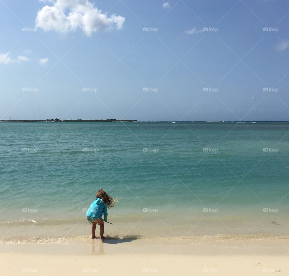 Small girl playing on beach