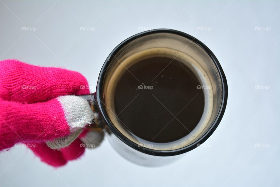 Close-up of person's hand holding coffee cup