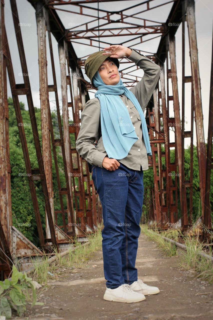 woman standing on the bridge