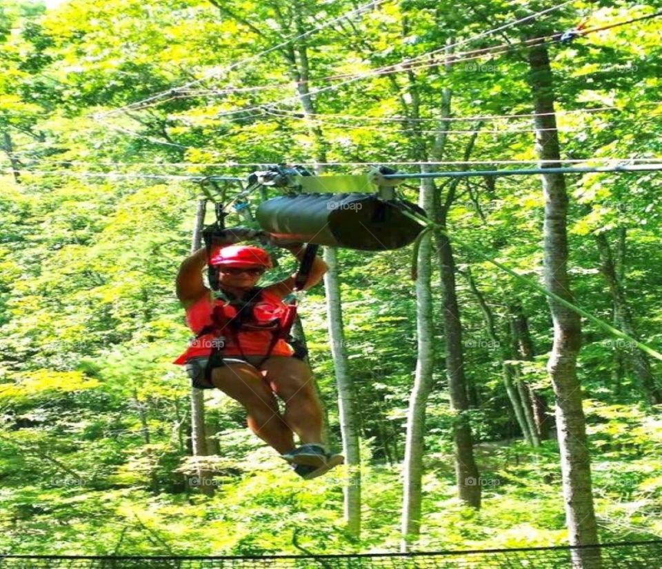 Adrenaline pumped summertime photo of me zip lining at Navitat Canopy Adventures in beautiful Asheville, NC.  