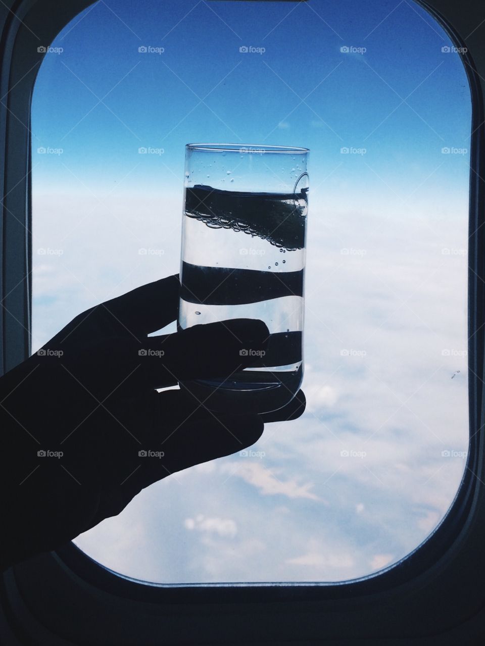 Hand holding glass of water