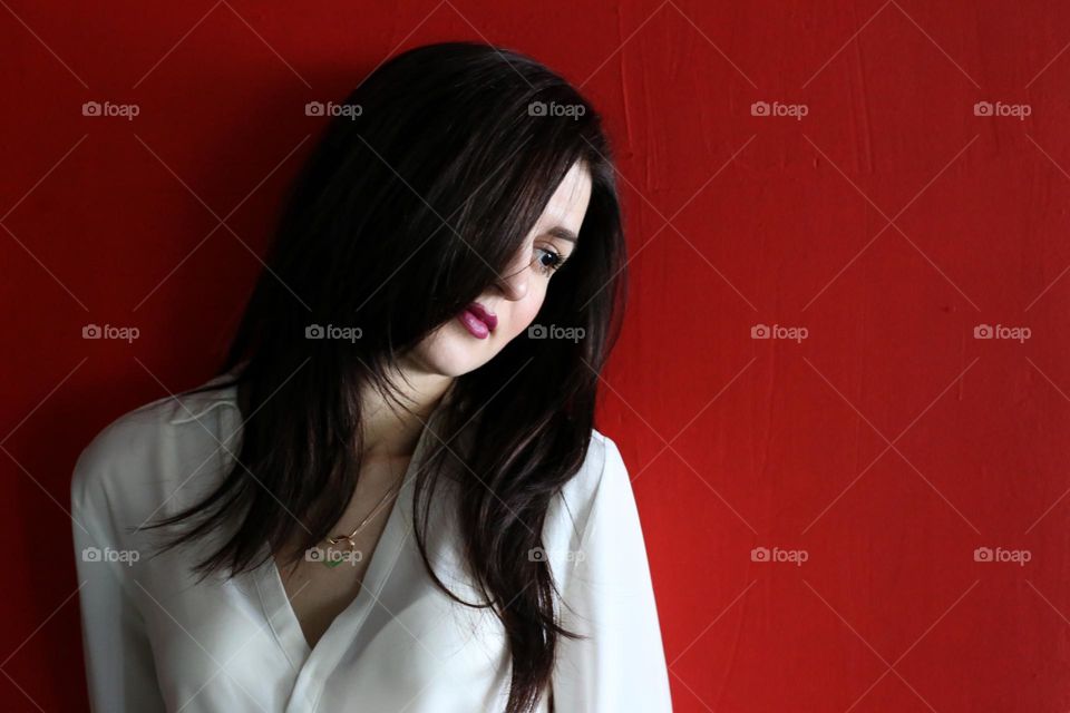 Portrait of beautiful woman on the red background 