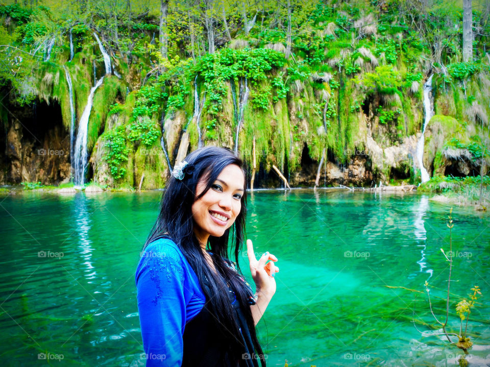 Asian woman standing near riverside