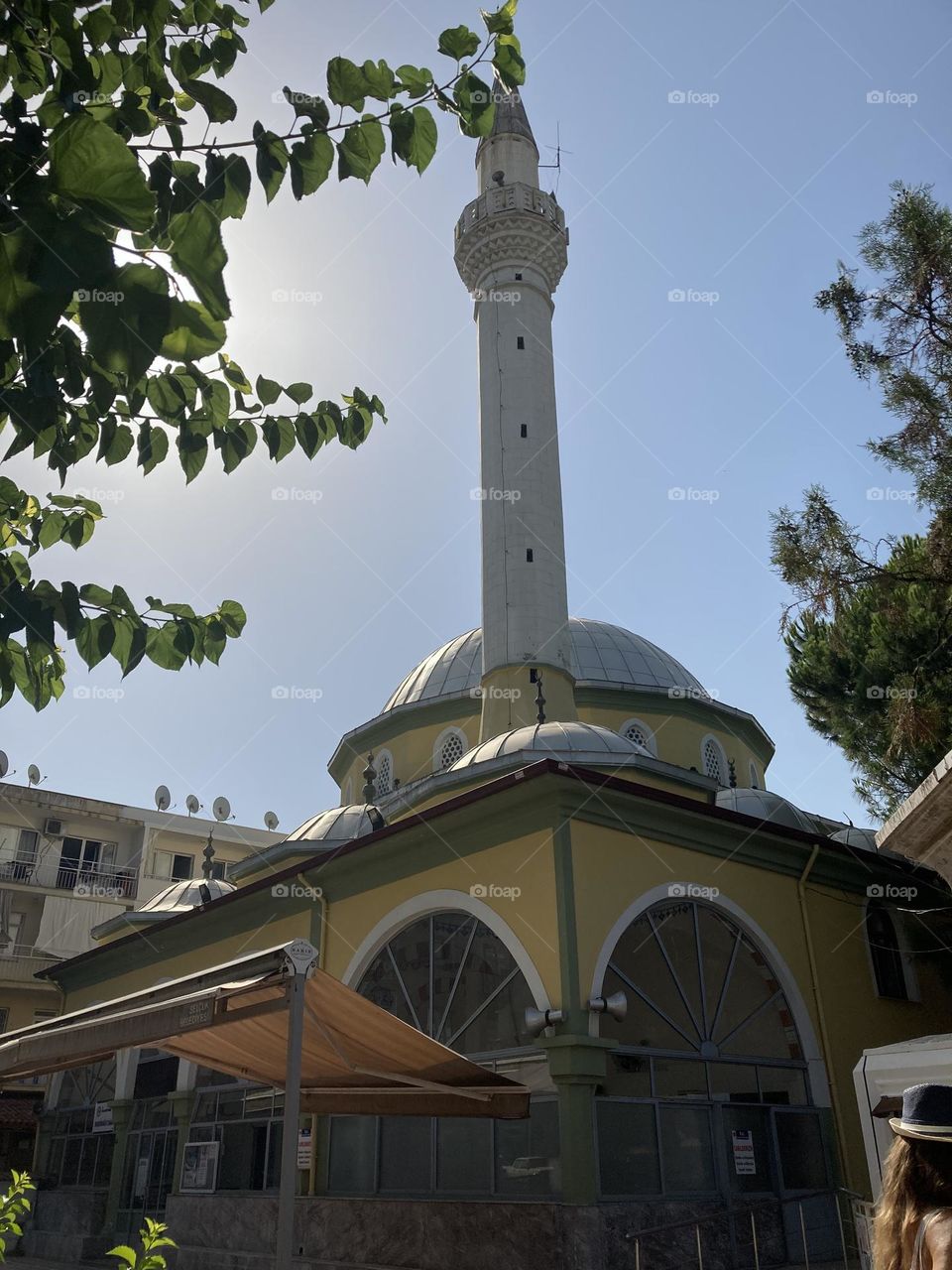 Sunny holidays I’m Turkey. Walk in the cute city and charming streets by the beach in Kusadasi. perfect blue sky and ocean view. Beach and the shore. To travel is to live. Gorgeous tall palm trees.