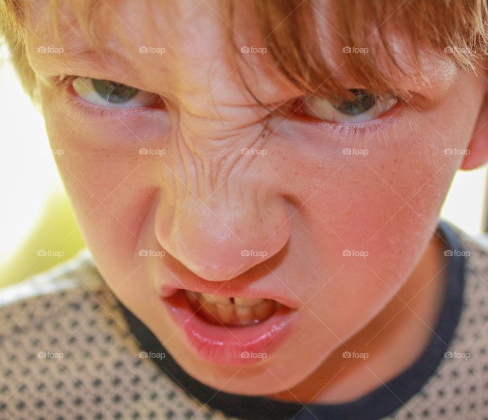 Temper temper. Young boy with an angry expression