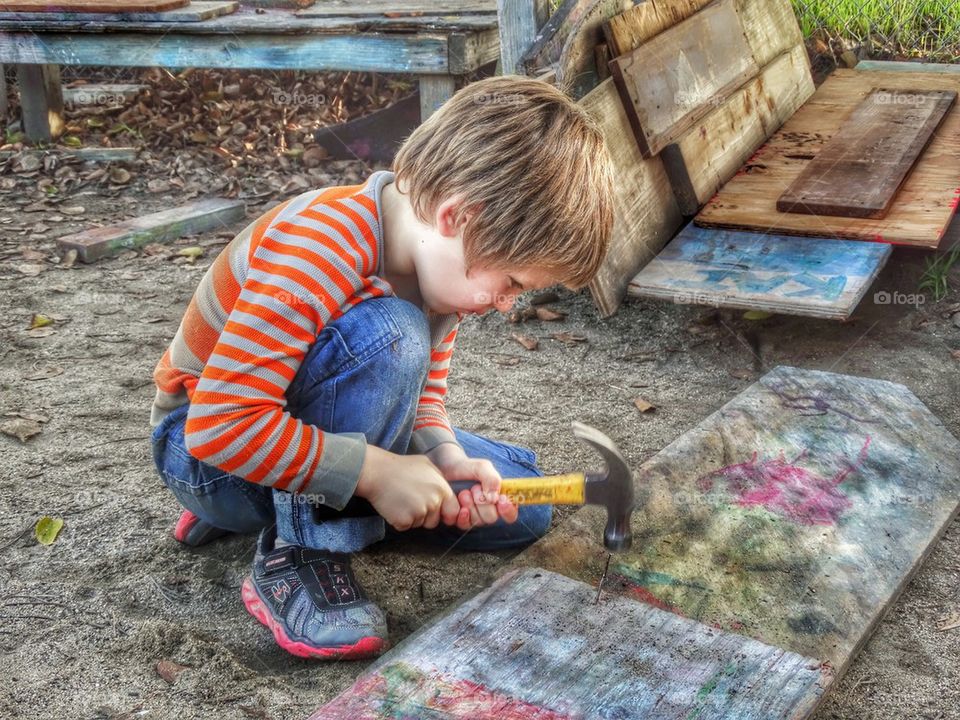 Young Boy Building A Treehouse With His Carpentry Skills. Young Boy Learning Carpentry
