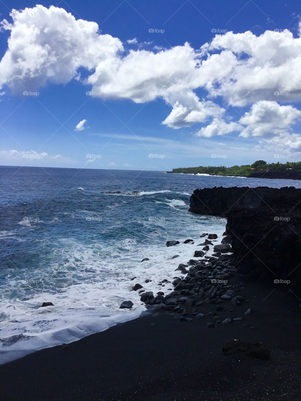 Black beach and white clouds