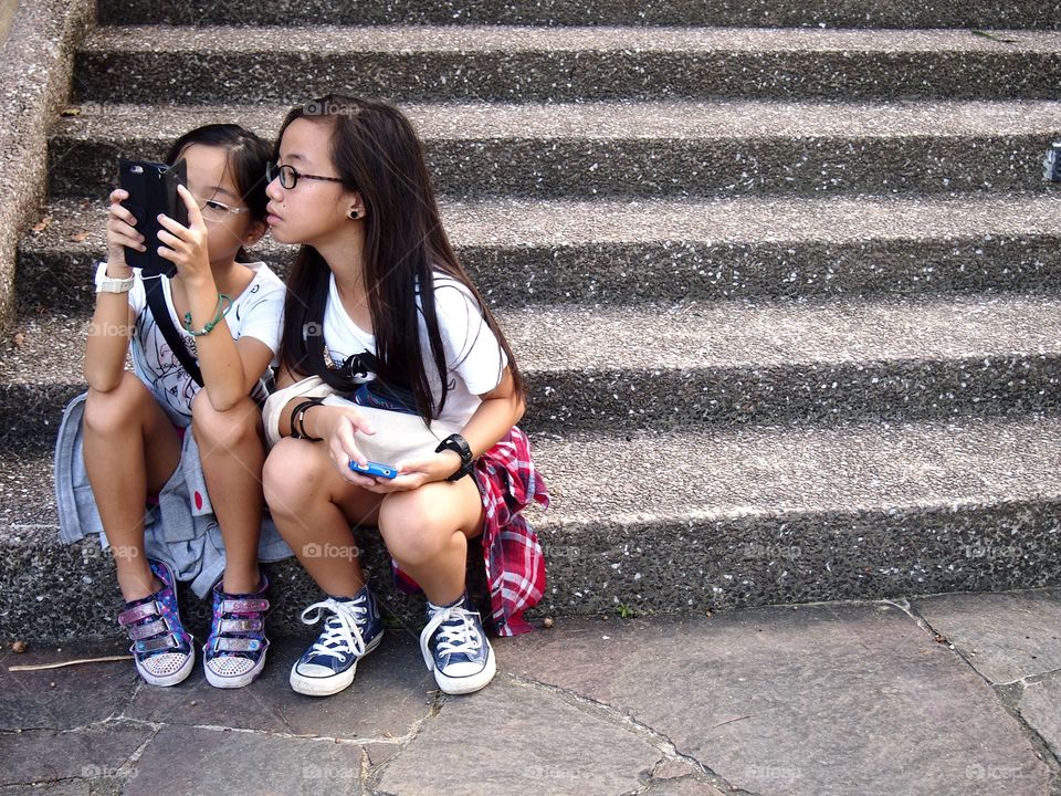 young girls using a cellphone or smartphone