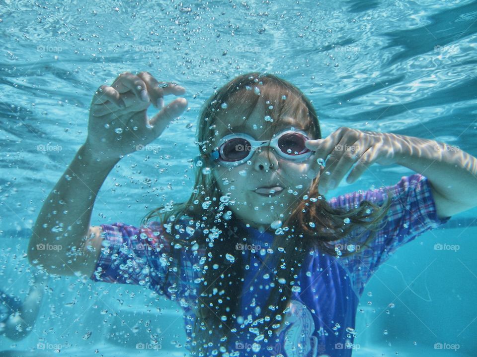 Little girl swimming underwater