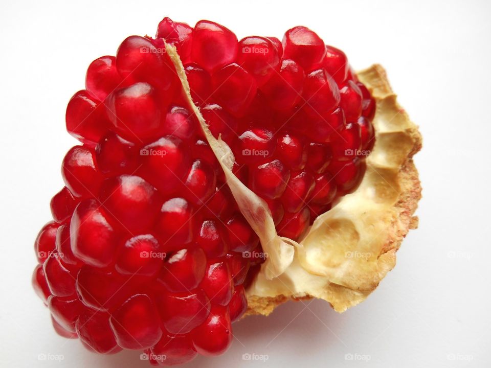 red pomegranate seeds healthy food white background