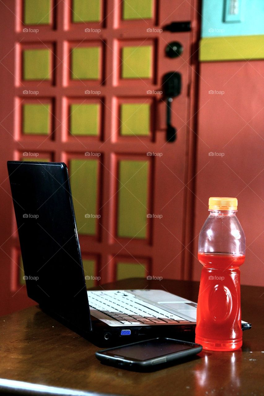 laptop computer, energy drink and smartphone