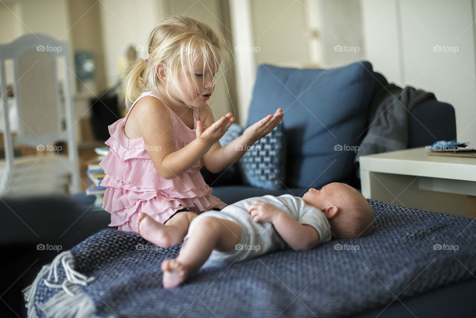 Sister invites her little brother to play