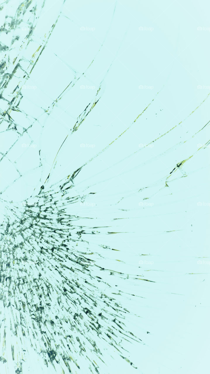 Multi-colored and bright broken smartphone screen close-up.