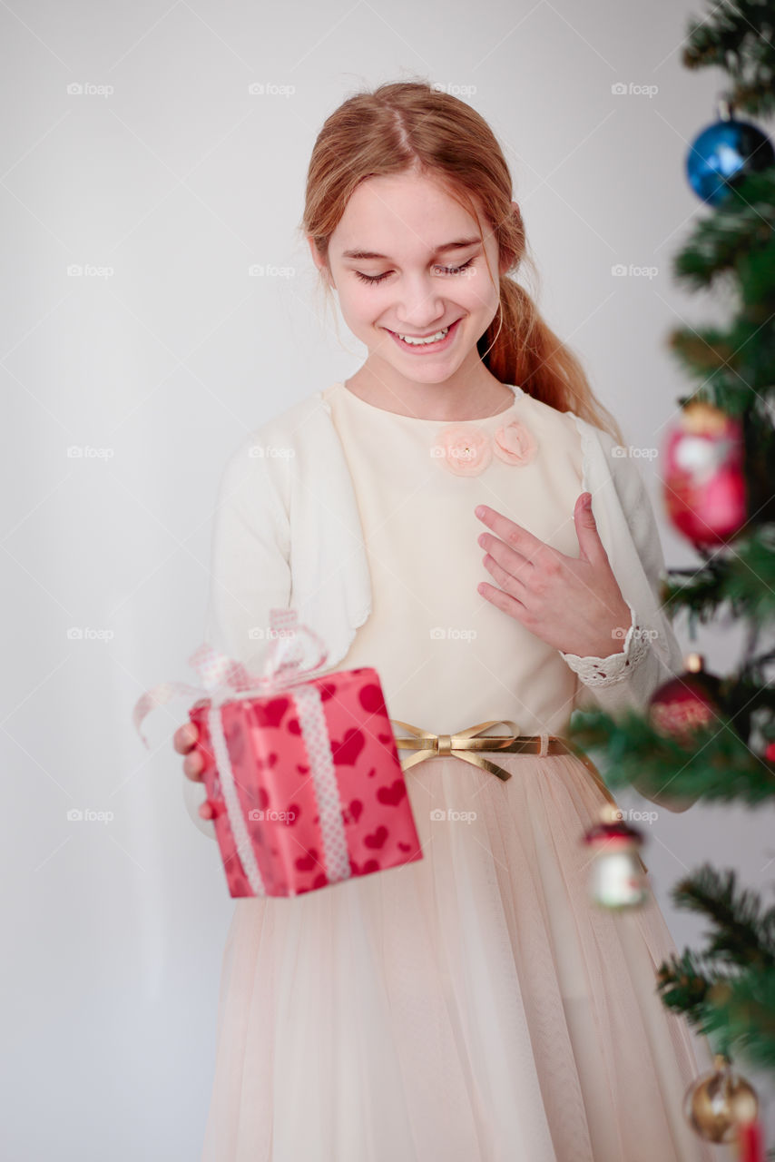 Portrait of a happy girl holing gift box