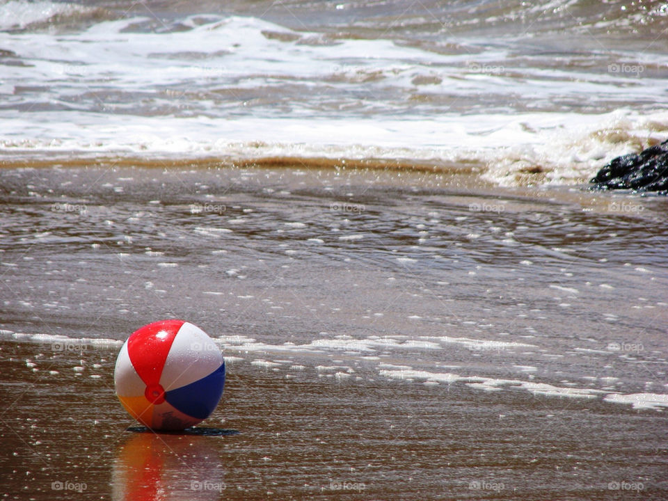 Lonely beach ball at a beach on Kauai