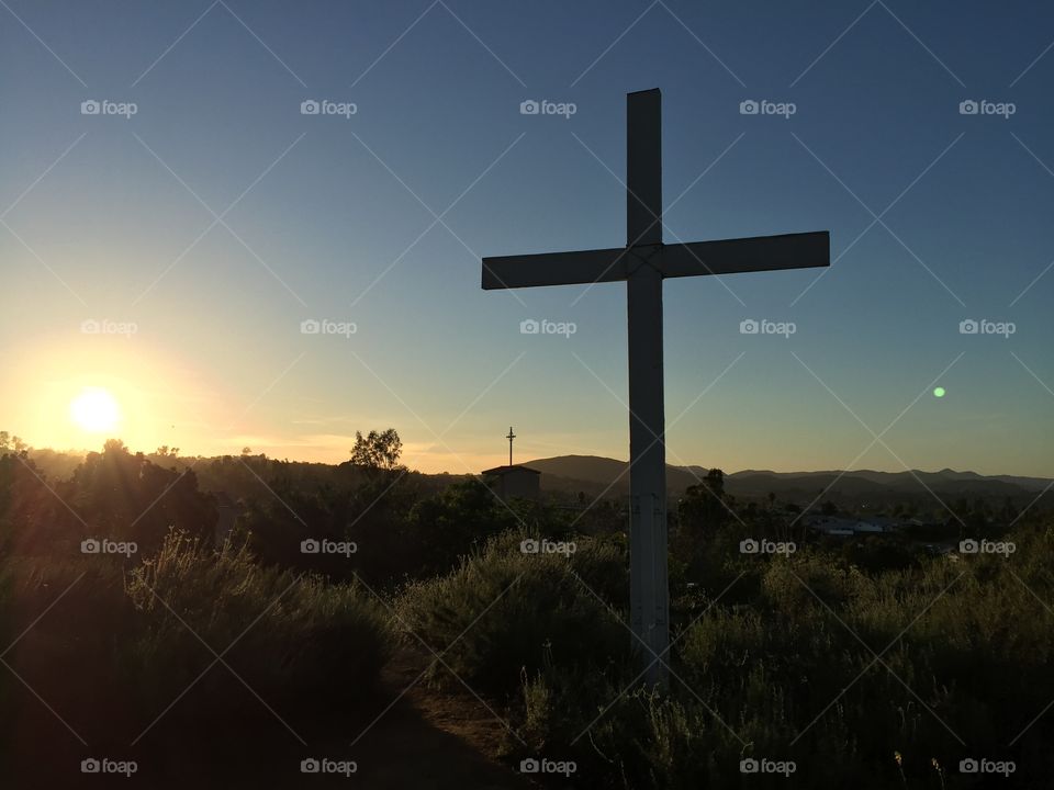 Good Friday sunset behind cross