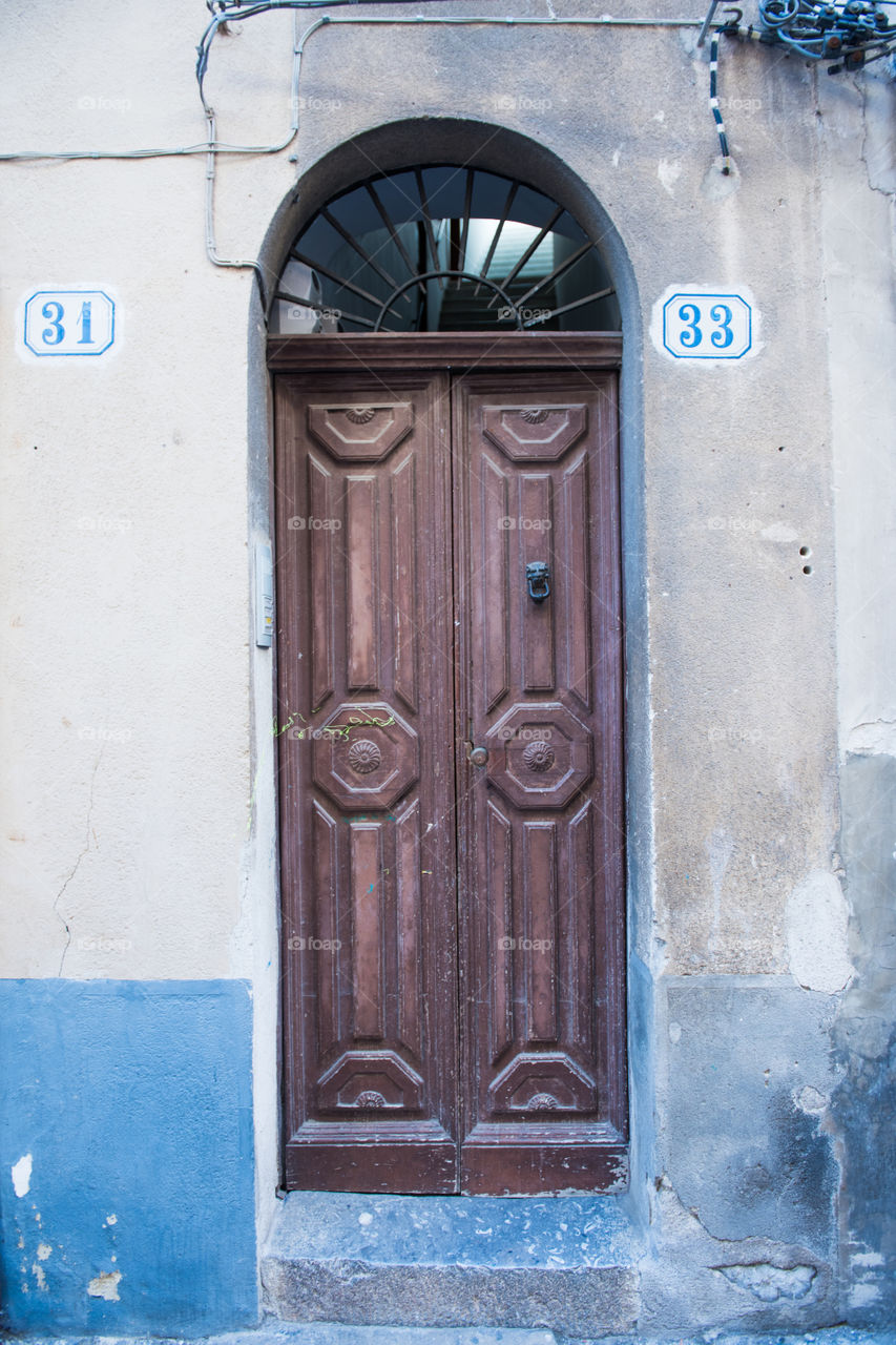 Old door in the city of Cefalu on Sicily.