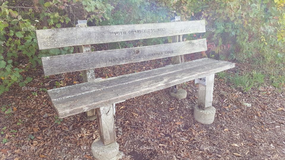 an old bench with a faded inscription of one of Lincoln's famous quotes, at the Abraham Lincoln Memorial Gardens