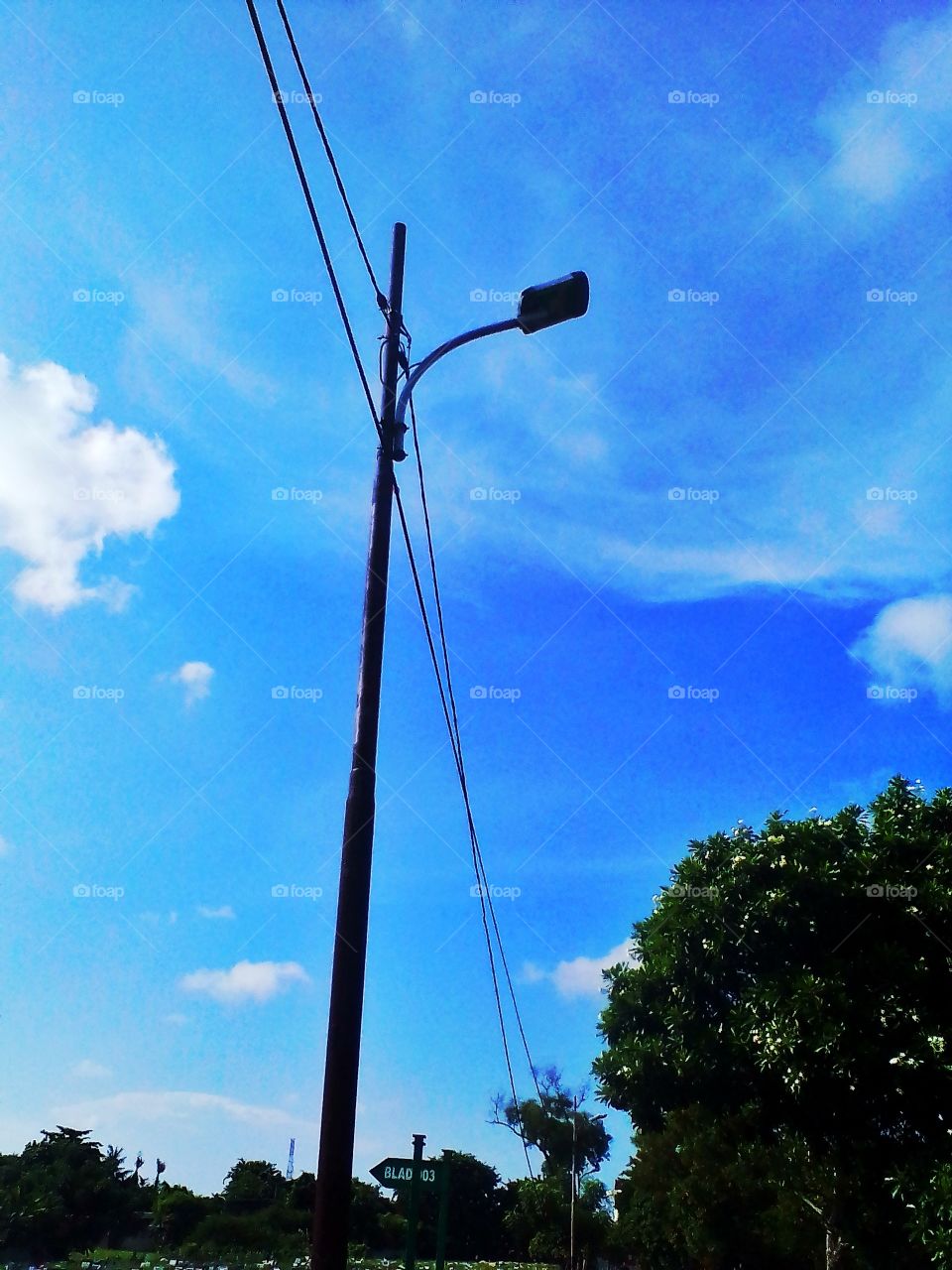 Electric poles that stand upright and straight on the side of the road challenge the heat of the sun