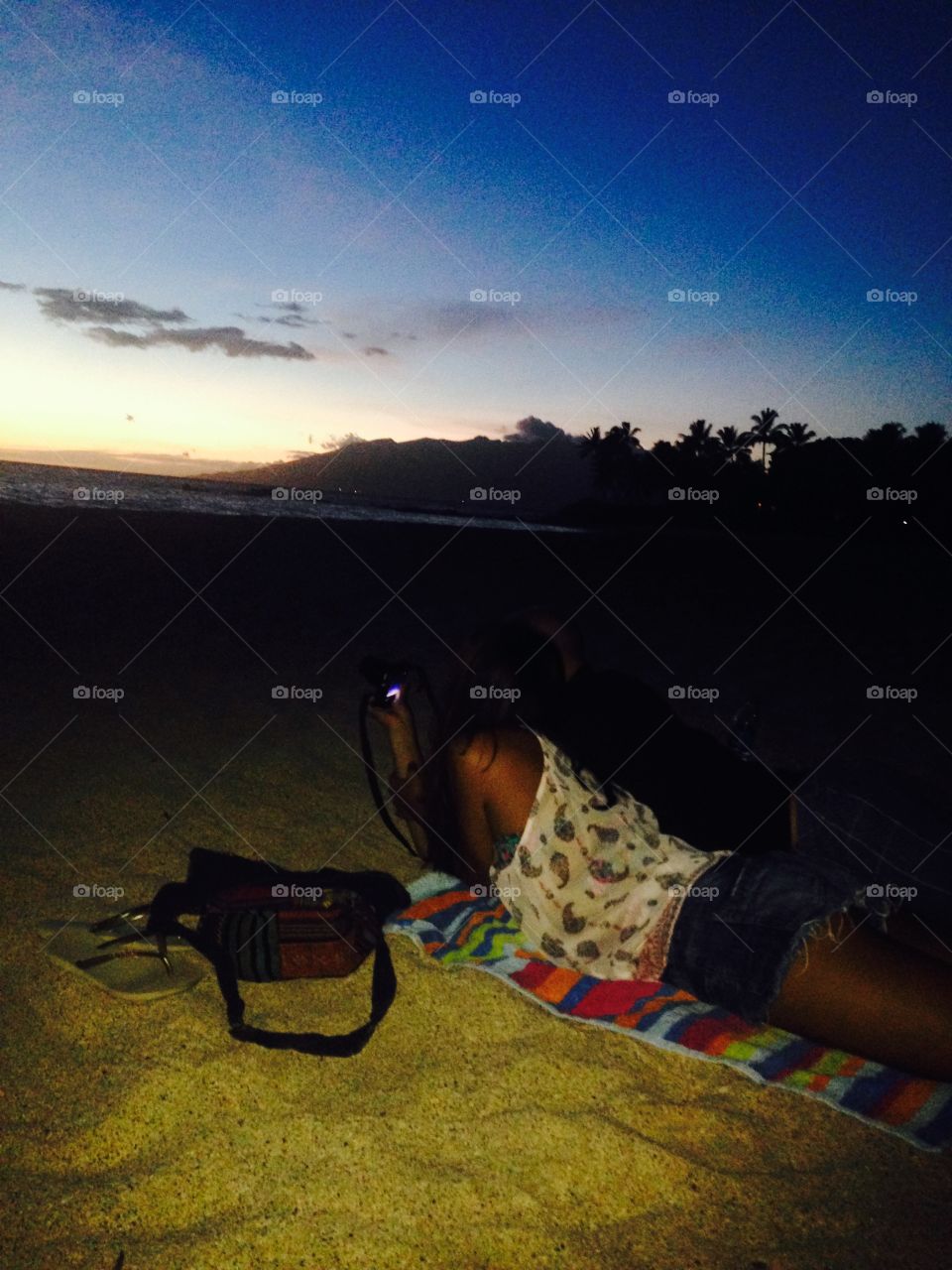 Beach viewing. Date on a blanket at sunset in Maui at the goldenhour