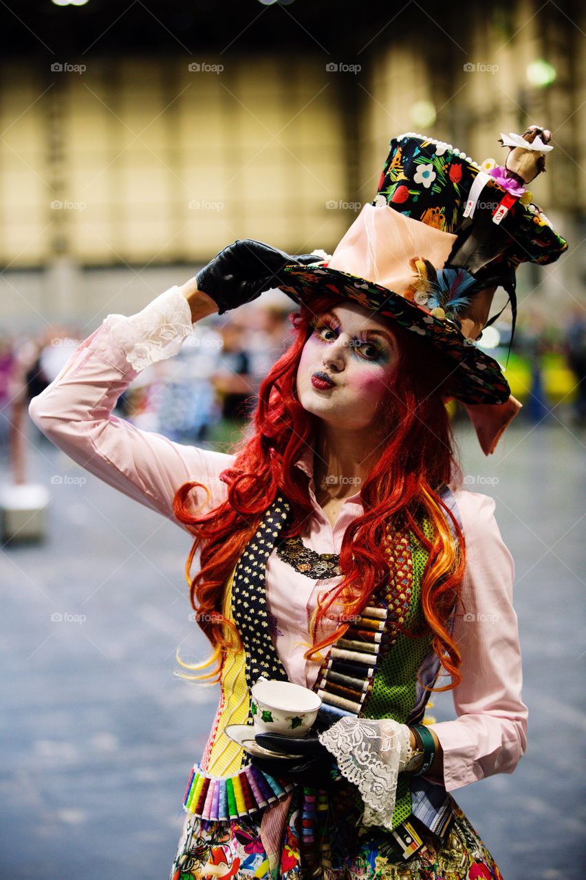 A girl cosplayer dressed as the Mad Hatter from Alice in Wonderland at a comic con event 