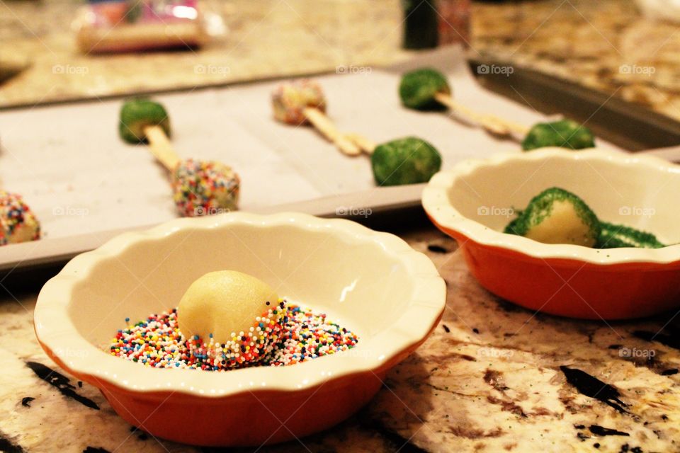 Putting sprinkles on the dough balls