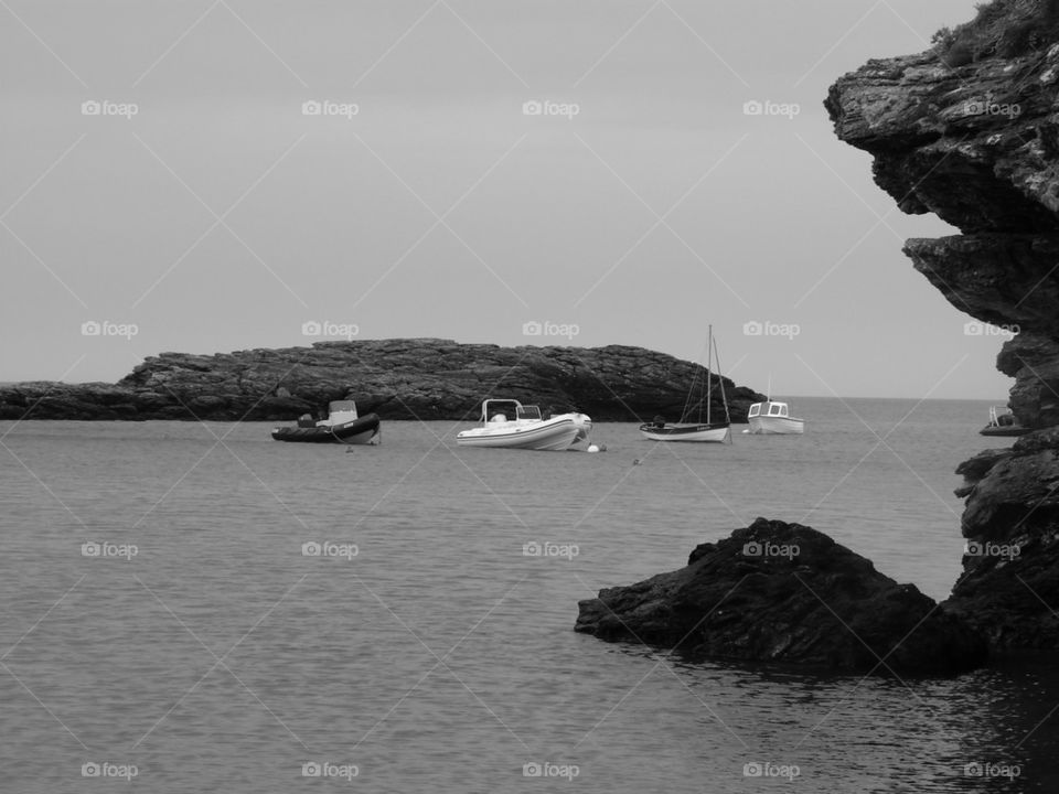 boats moored in a rocky bay