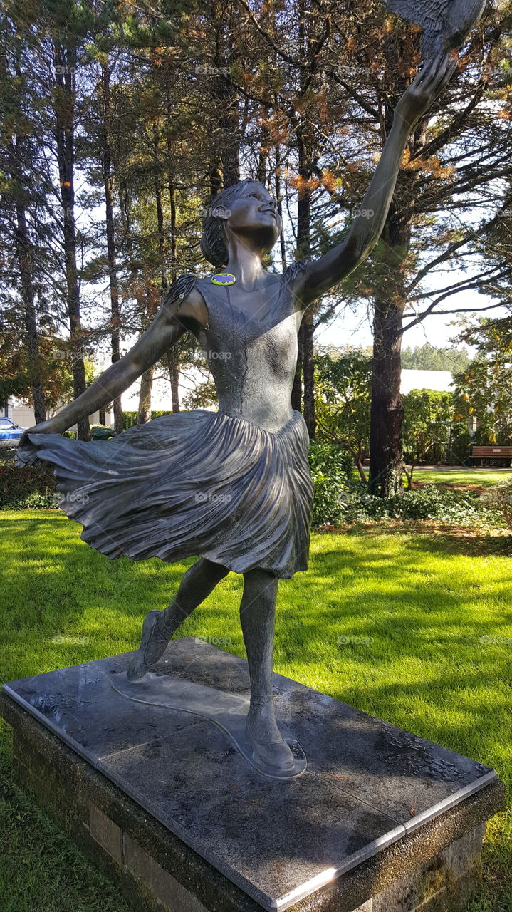 Sculpture of a ballerina with a painted Batman rock hidden on shoulder