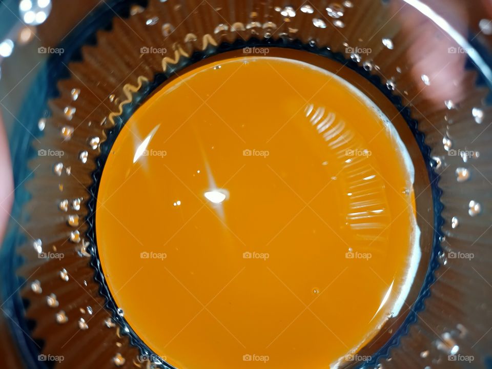 looking shiny under light when juices are under transparent glass.