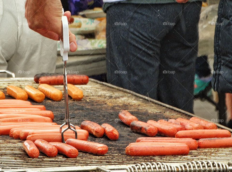 Hot Dogs Cooking On The Grill