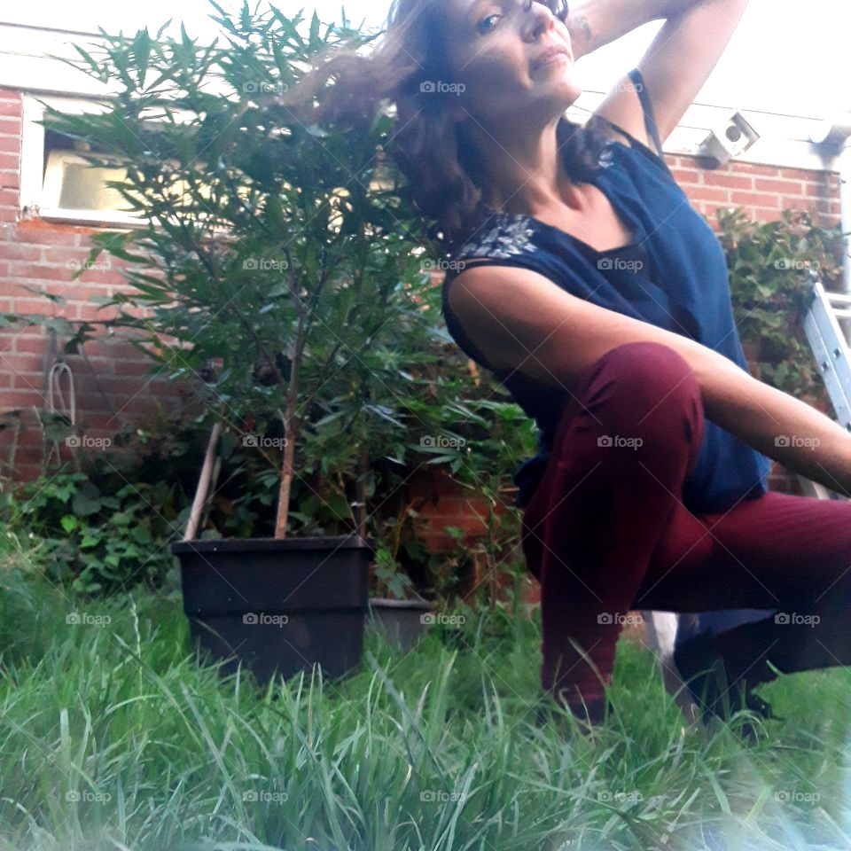 Take a pose and take a picture with the weed plant